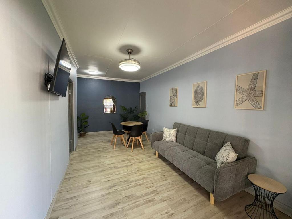 a living room with a couch and a table at The Marley in Polokwane