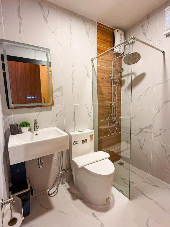 a bathroom with a toilet and a sink and a shower at The View A-Frame Cabin in Chiang Dao