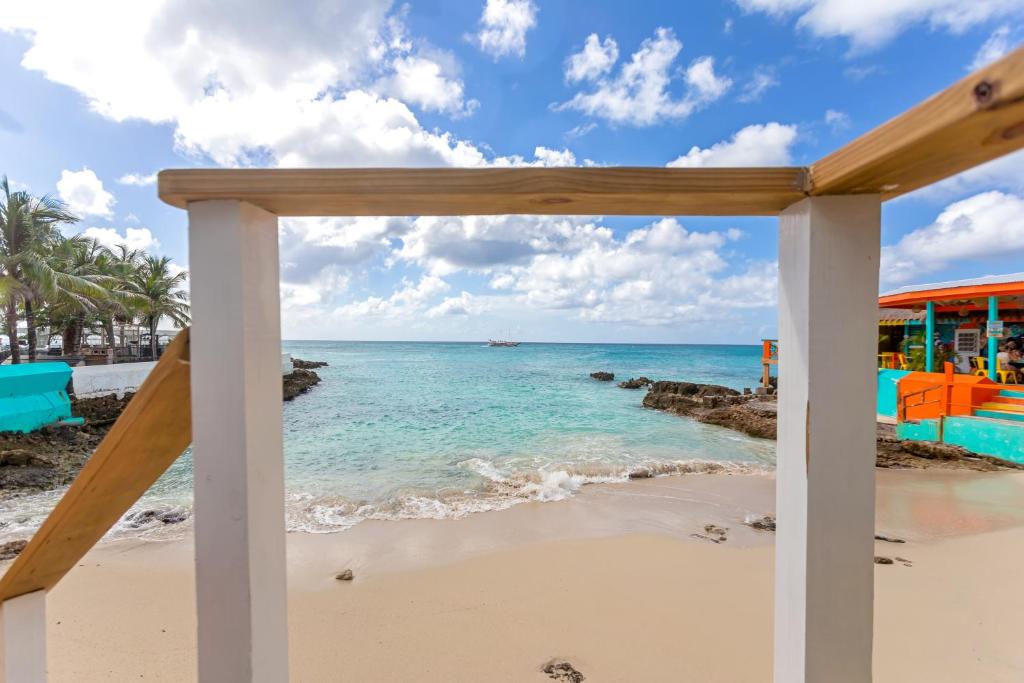 a view of the beach from the porch of a beach house at Maho Beach House - Studio - Beach Access in Maho Reef