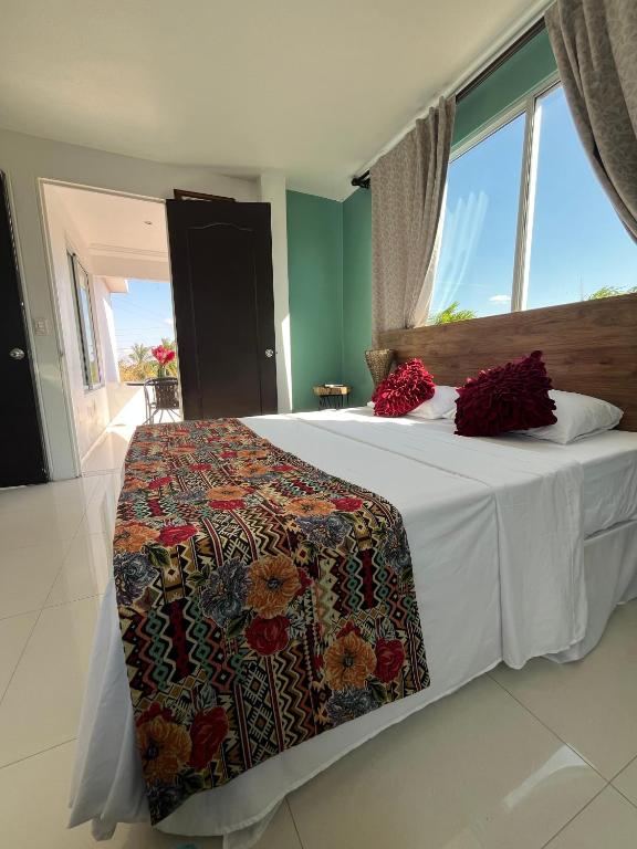 a bedroom with a bed with a blanket on it at Yopo Resort in Yopal