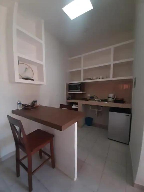 a kitchen with a table and a chair in a room at Nice apartment in the north in Hermosillo