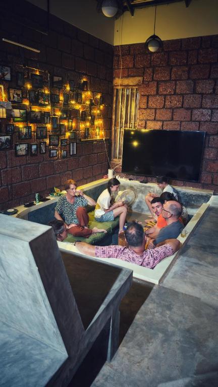 a group of people sitting in a swimming pool at Vyugen Villa #01 in Kāraikkudi