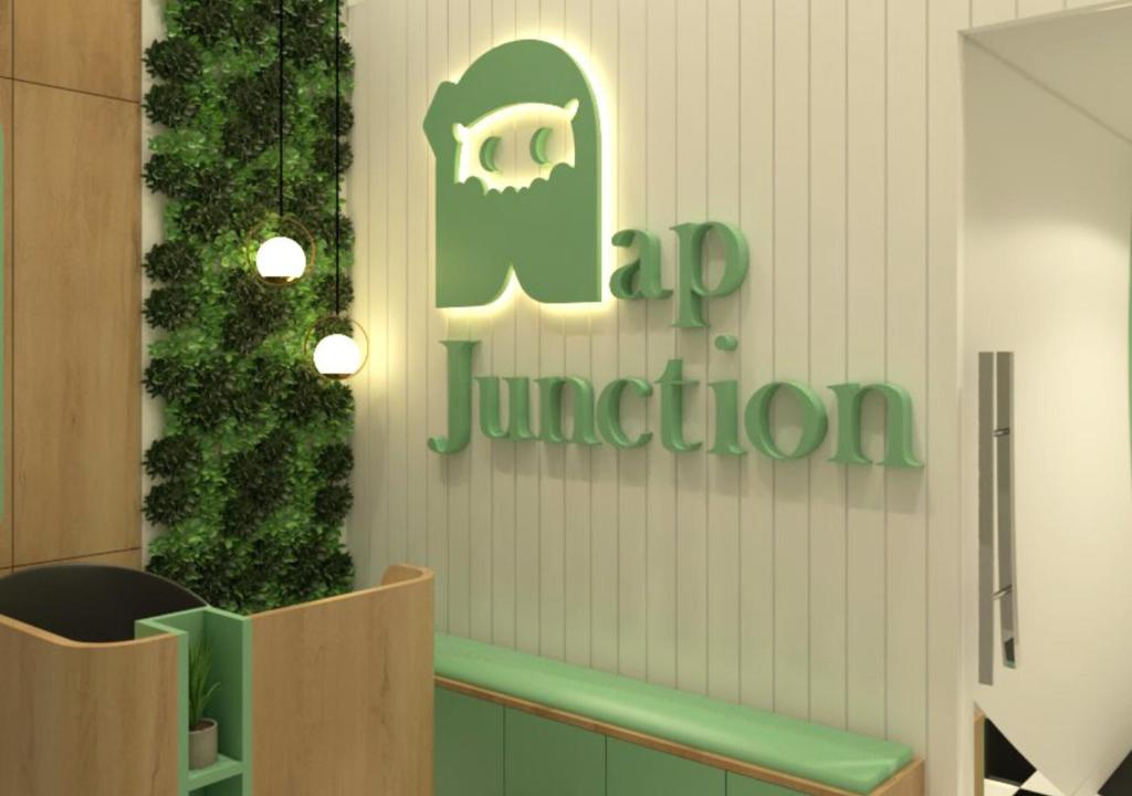 a sign for a jmu junction on a building at Nap Junction in Pune