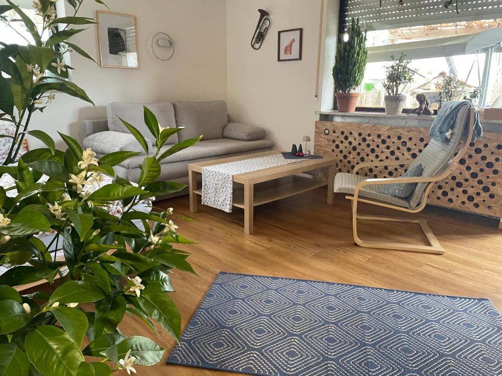 a living room with a couch and a chair at Glücksmomente in Wolfegg
