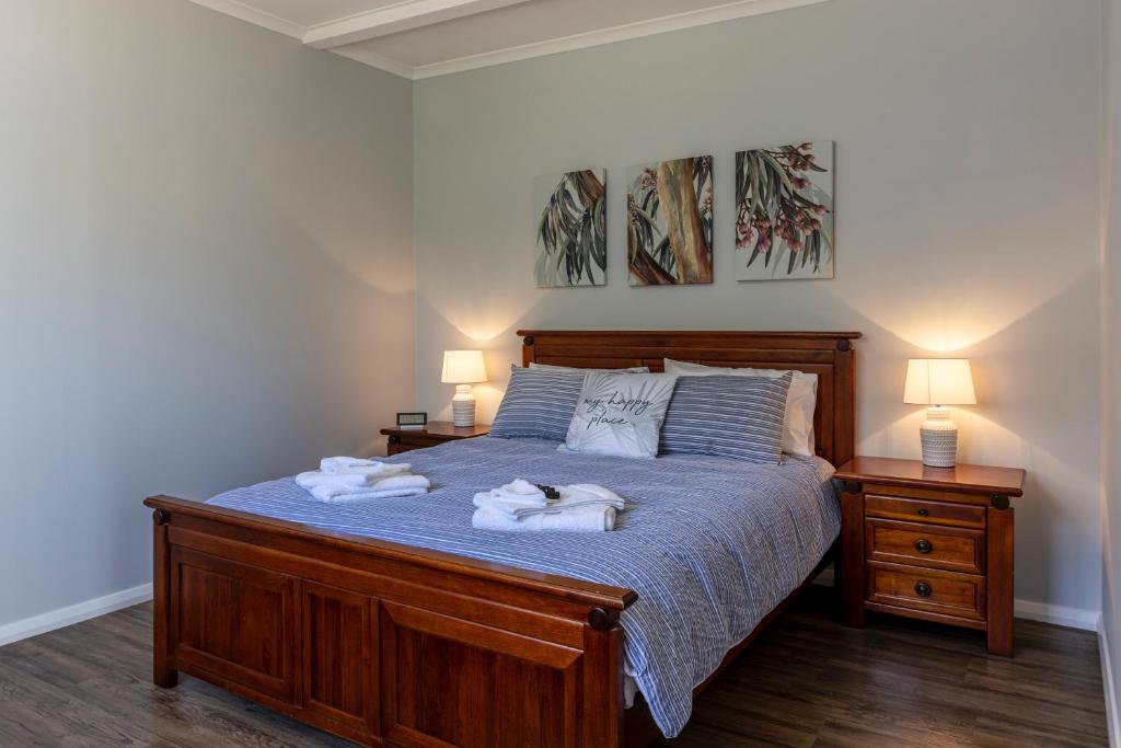 a bedroom with a bed with two towels on it at Topp House Retreat in Bethany