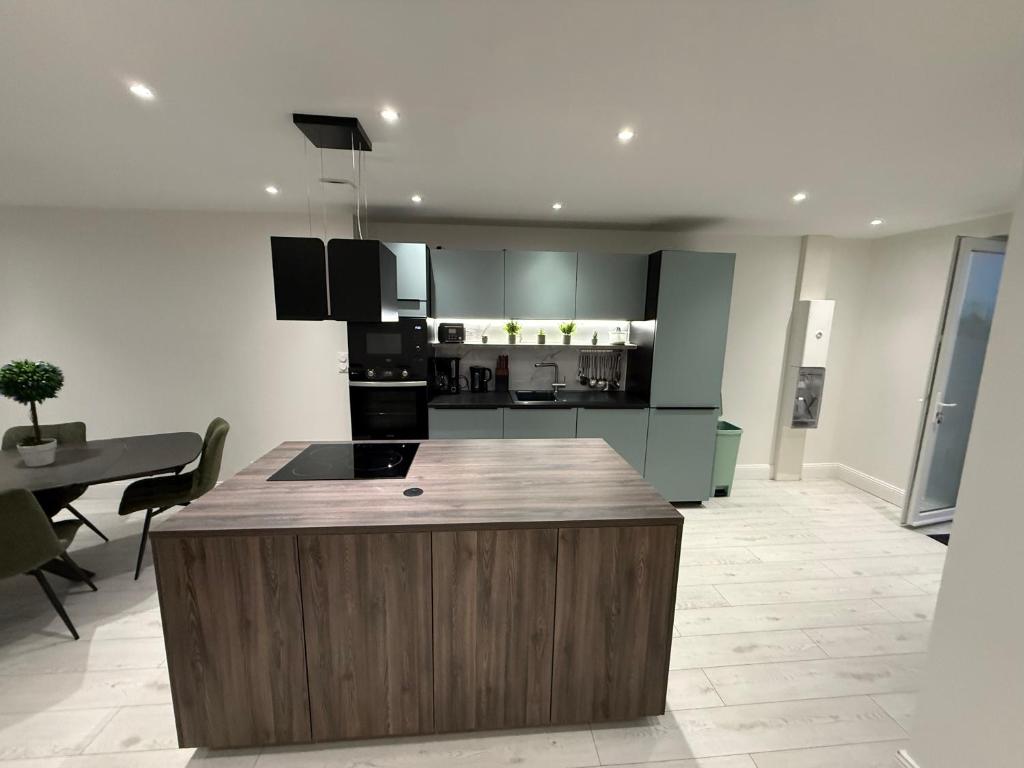 a kitchen with a island in the middle of a room at Le Panoramique in Saint-Parize-le-Châtel