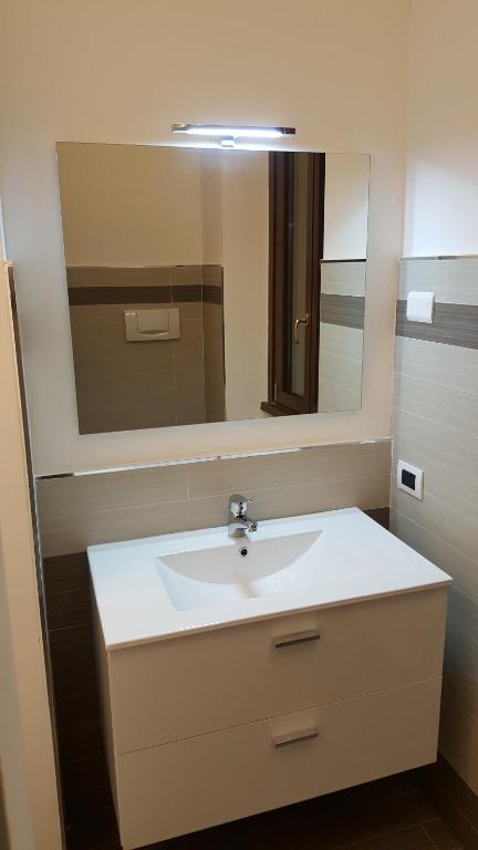 a bathroom with a white sink and a mirror at B&b La Corte di Brusuglio in Cormano