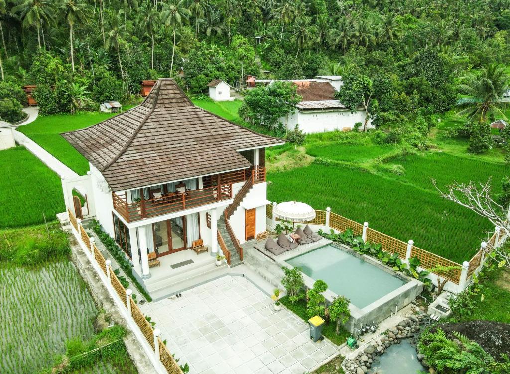 an aerial view of a house with a swimming pool at Semu Villa - Three Bedroom Private Pool Villa in Pawenang