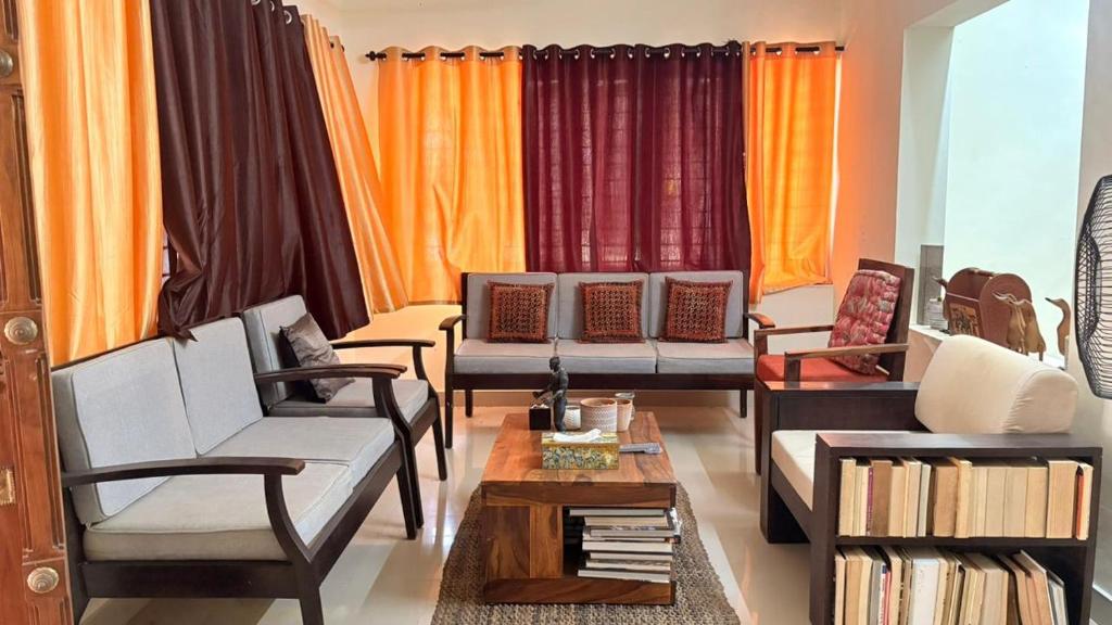 a living room with couches and a coffee table at Casa Areca in Cheruthuruthi
