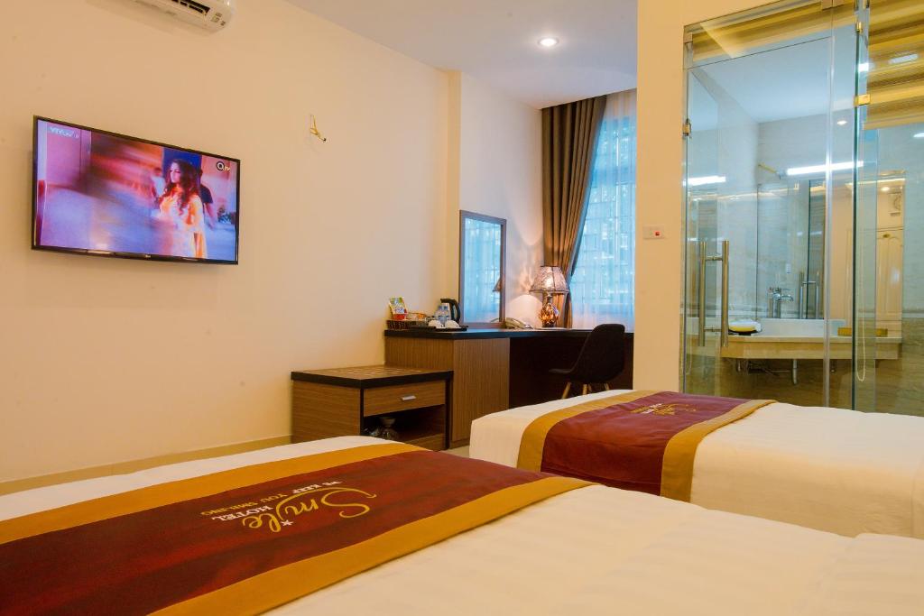 Postel nebo postele na pokoji v ubytování Smile Hotel