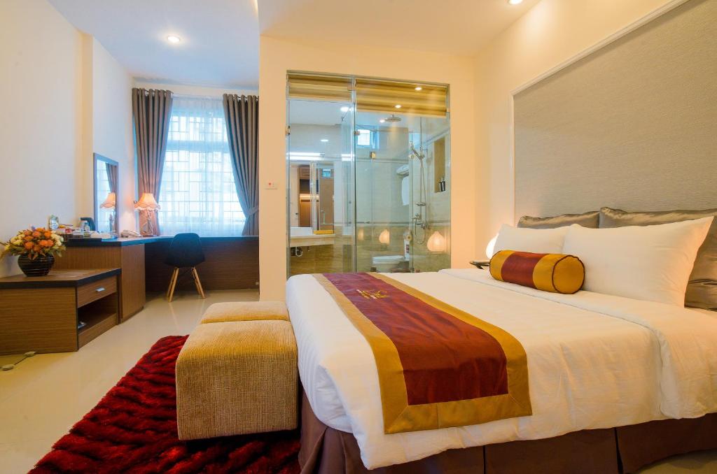 a bedroom with a large bed and a shower at Smile Hotel in Hanoi