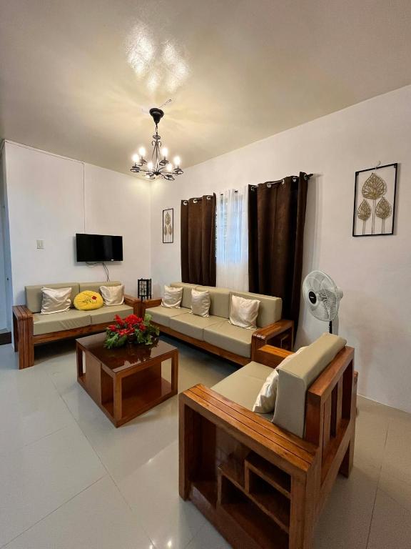 a living room with two couches and a tv at Villareal Homestay in Coron