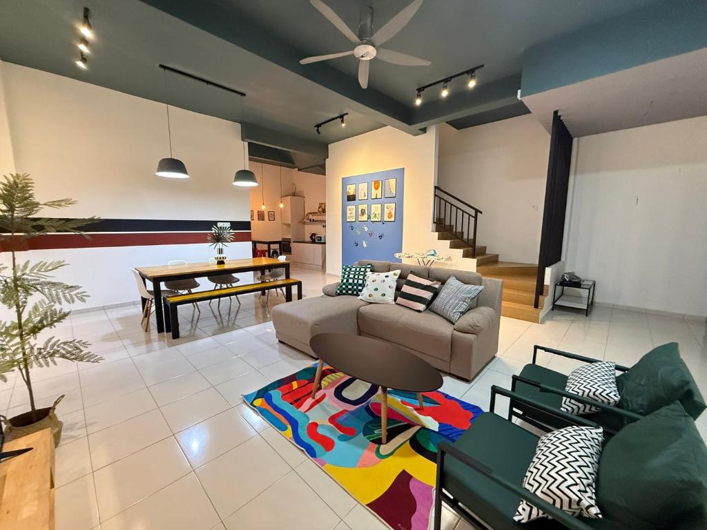 a living room with a couch and a table at R3troHouse3 4BR 14PAX Near188Tower, HTAA, In Town in Kuantan