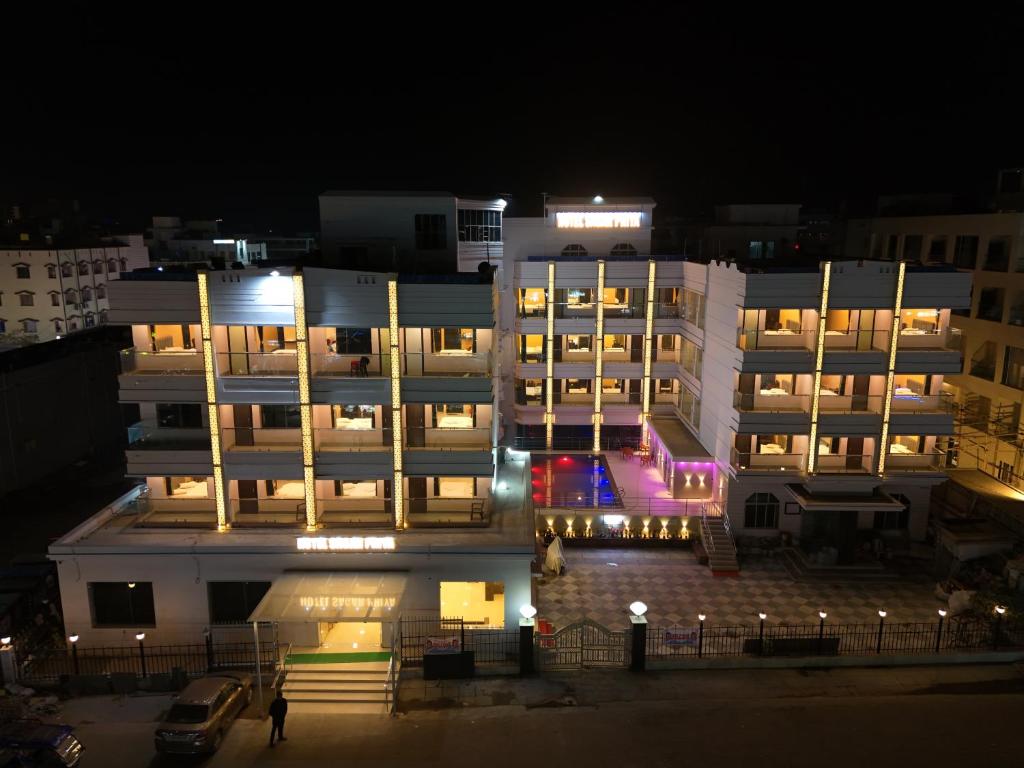 a large white building at night with lights at Hotel SagarPriya in Digha