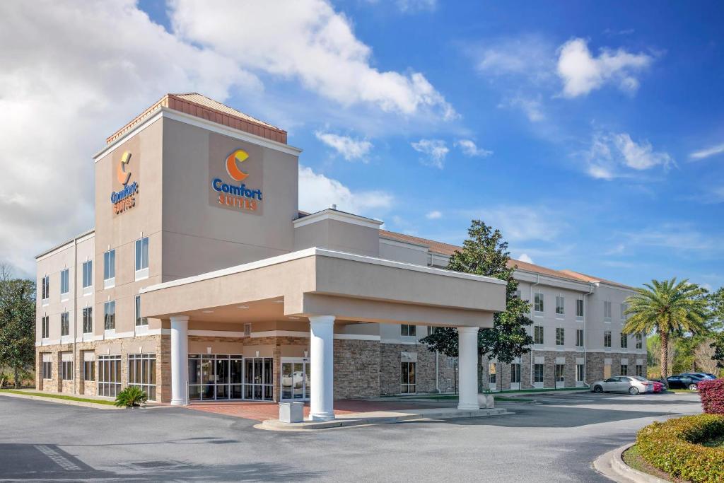 a hotel with a sign on the front of a building at Comfort Suites Brunswick in Brunswick