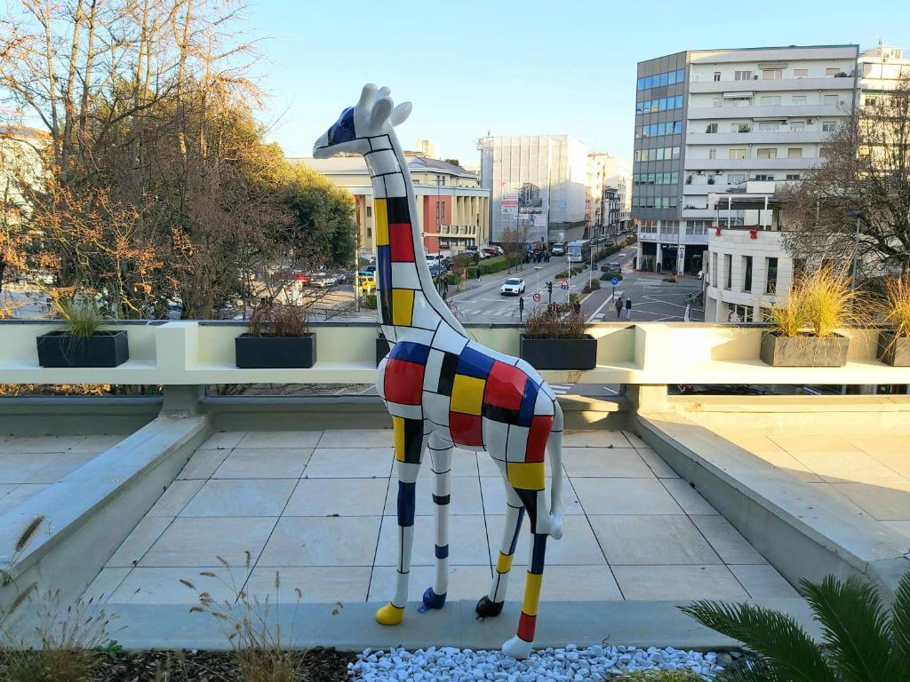 a statue of a giraffe on a ledge at Apartments Marini in Pordenone