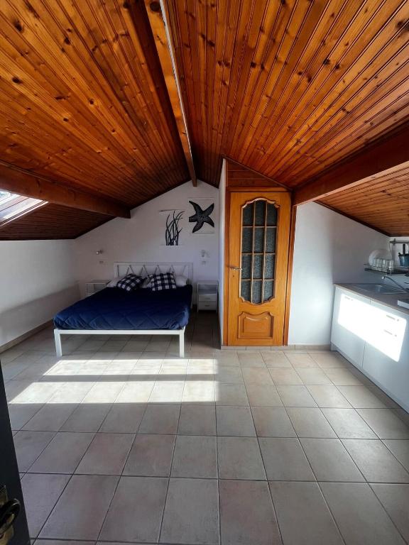a room with a bed and a wooden ceiling at Terrazza Belvedere Sanremo in Sanremo