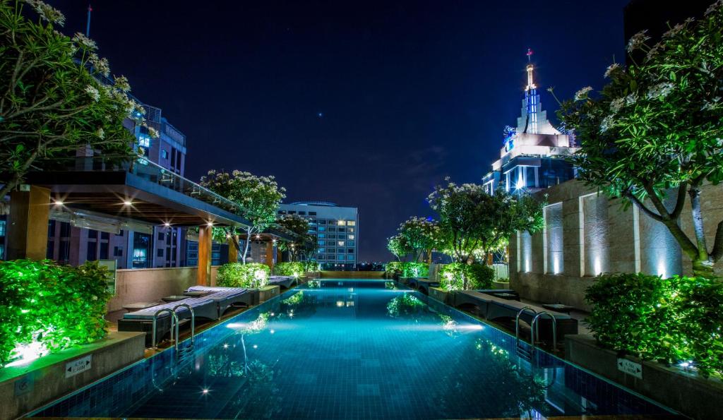 a swimming pool in a city at night at Oakwood Premier Prestige Bangalore in Bangalore