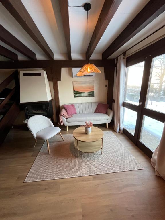 a living room with a couch and a table at Le chalet de Pfaffenbronn in Lembach