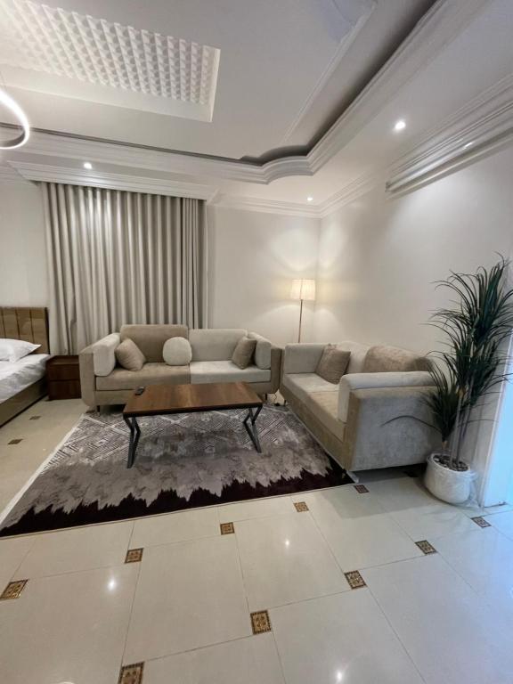 a living room with a couch and a coffee table at ADEL Privet Hostleإيواء خاص in Taif