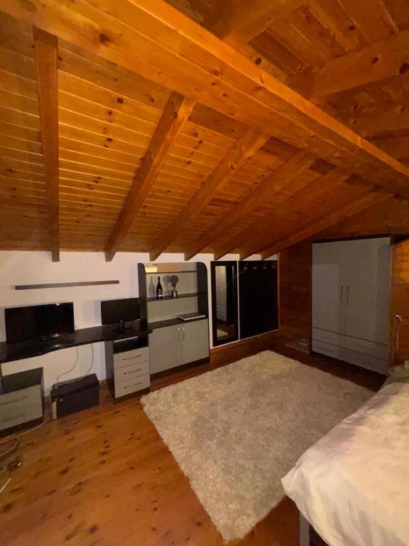 a large room with a bed and a wooden ceiling at Gem Guest House in Lazarat