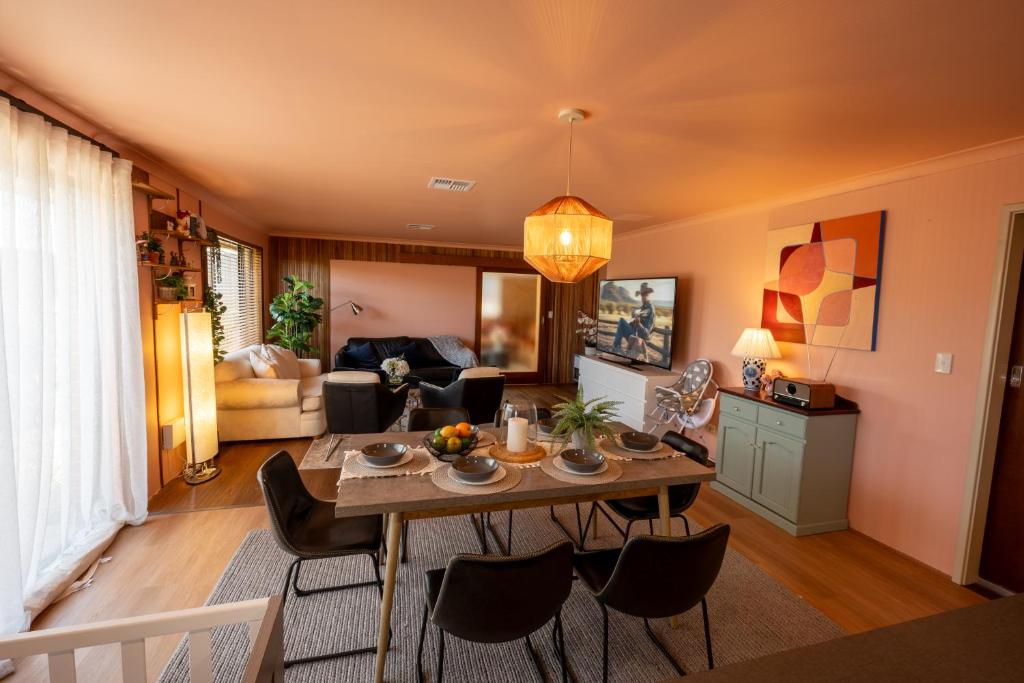 a living room with a table and chairs at Spearwood Little Getaway in Spearwood