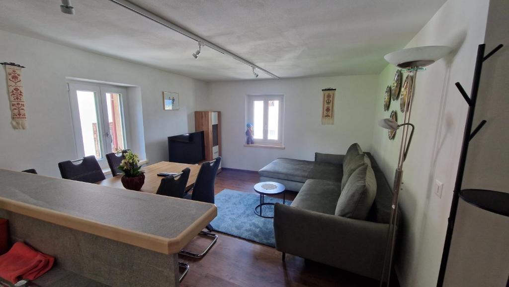 a living room with a couch and a table at Ferienwohnung Tulipana in Müstair