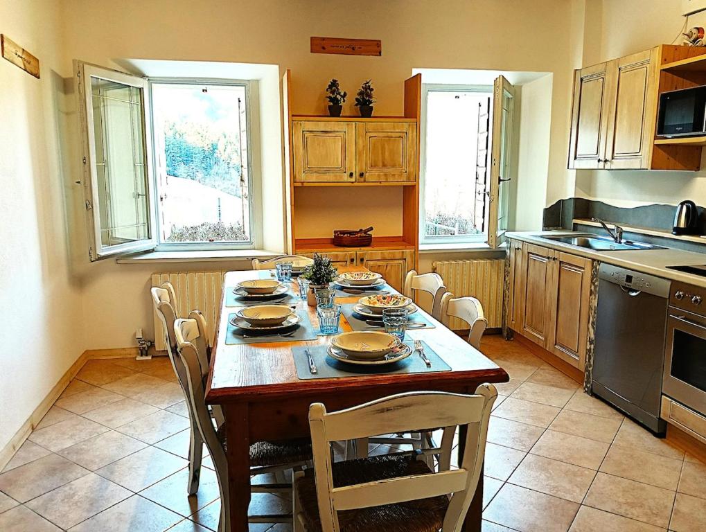 a kitchen with a wooden table with dishes on it at La Casa dei Nonni in Caralte