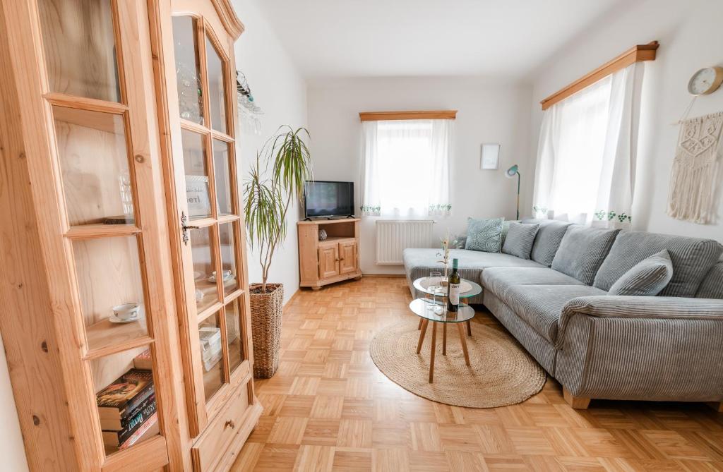 a living room with a couch and a tv at Weingut Dietl in Riegersburg