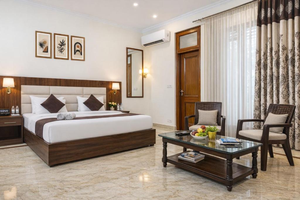 a hotel room with a bed and a table at Hotel Warm Welcome Inn Noida Sector 51 in Noida