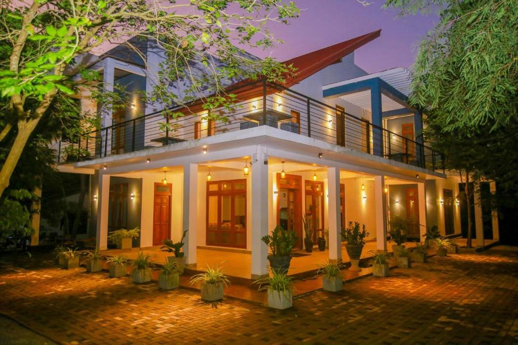 a large house with potted plants in front of it at Ayana Resort Wilpattu in Wilpattu