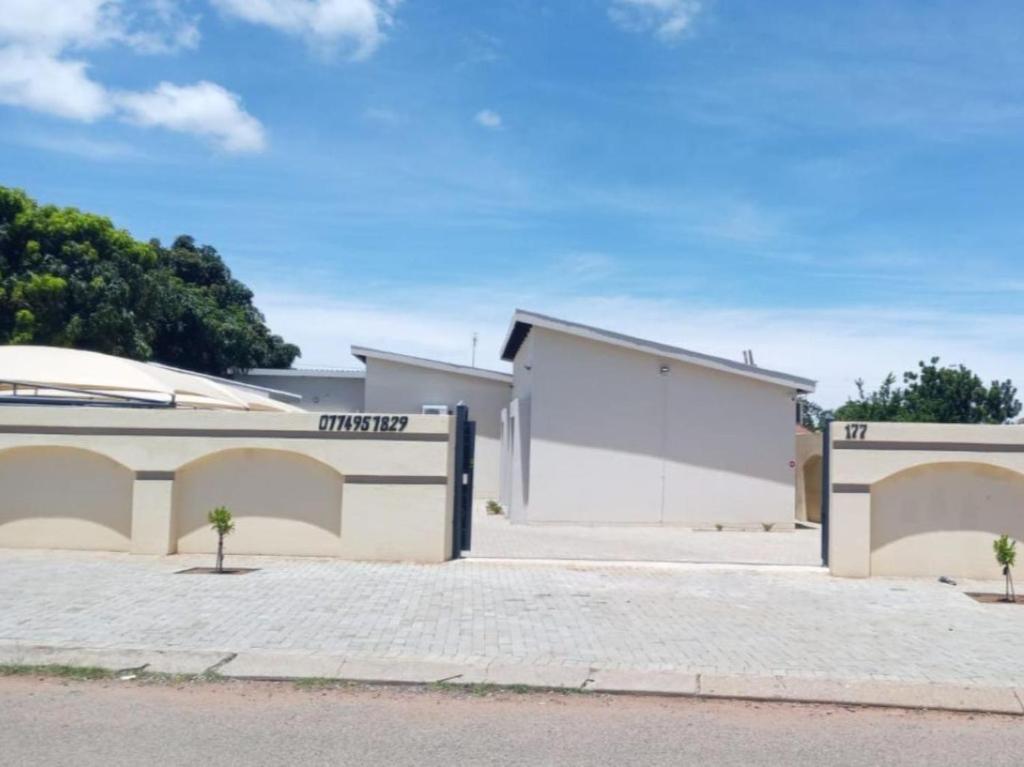 a house with two garage doors on a street at The Botik Hides in Mogwase