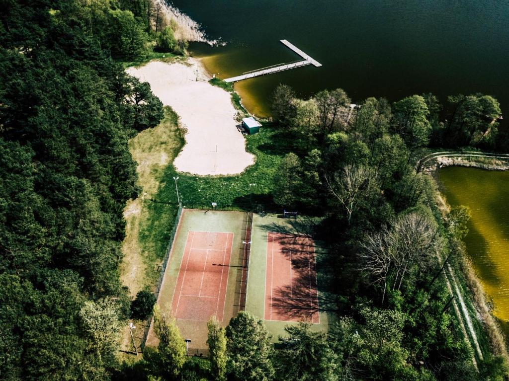 an aerial view of an island in a lake at Leśna Ryba I Domki nad jeziorem z parkiem linowym in Jedlanka Stara