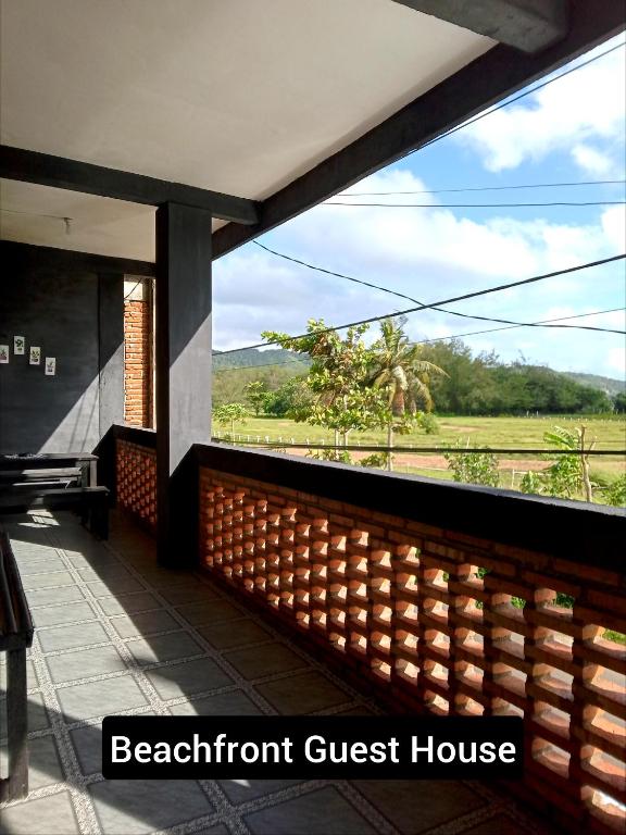 a balcony with a view of a guest house at Beachfront Guest House Pacitan in Tamperan