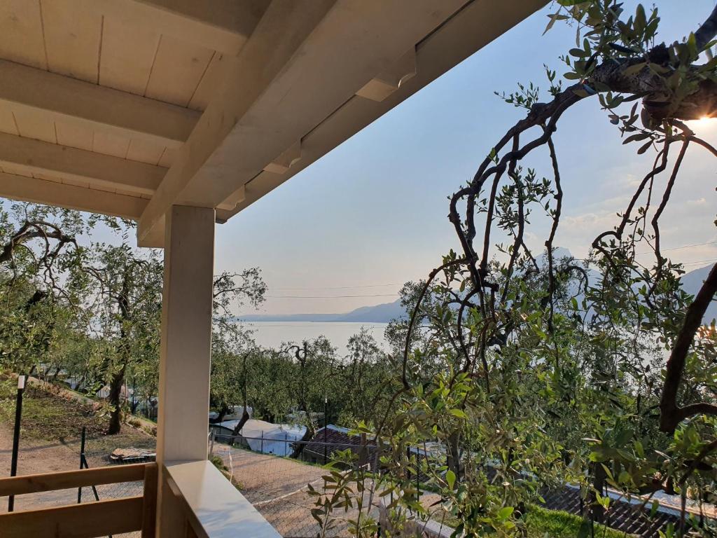 a view of the ocean from the porch of a house at Camping Le Maior in Brenzone sul Garda