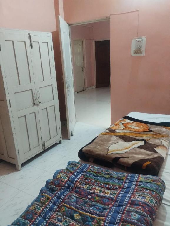 a bedroom with a bed and a door and a rug at affordable homes in Prayagraj