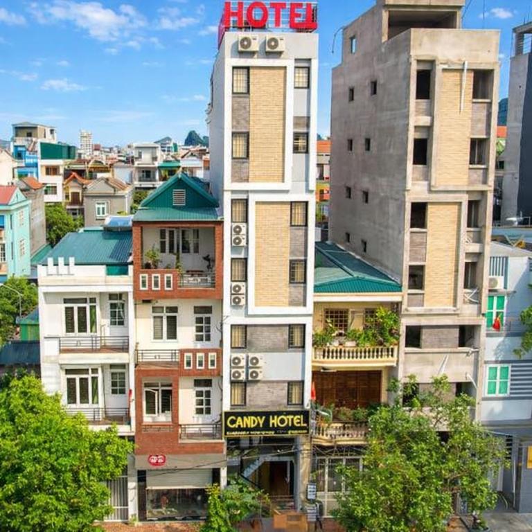 a tall building with a clock tower in a city at Candy Hotel Hạ Long in Ha Long