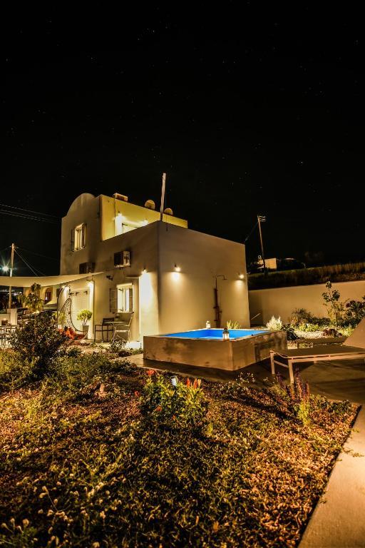 a house with a swimming pool in front of it at night at JB Villa in Mesaria