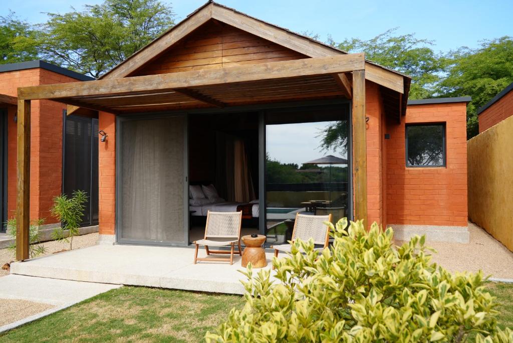 a house with two chairs sitting on a patio at Aerys Village in Somone