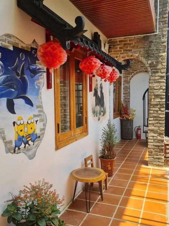 a patio with a table and a painting on the wall at Homestay Xóm Rớ in Ðông Tác (1)