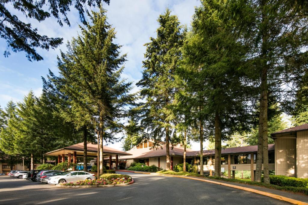 a street in front of a building with trees at Olympia Hotel at Capitol Lake in Olympia