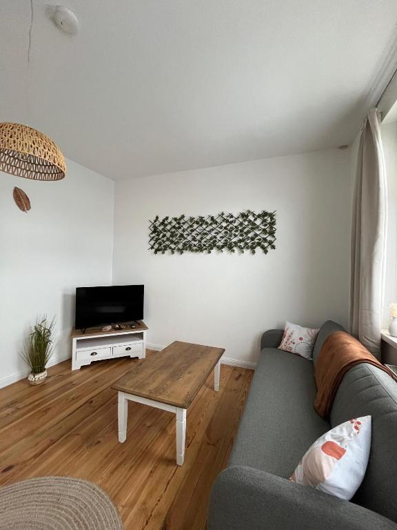 a living room with a couch and a table at Wohnung HoMe No 17 in Parchim