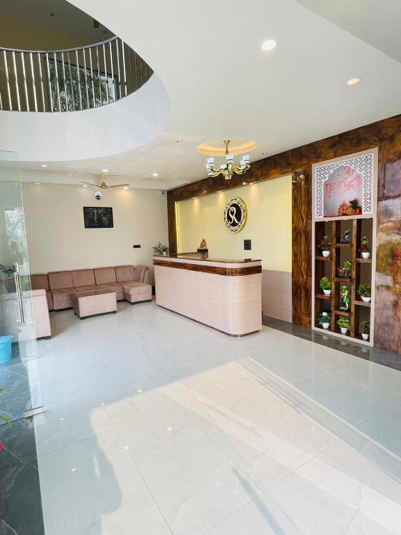 a large lobby with a reception desk in a building at SR Resort in Milkīpur