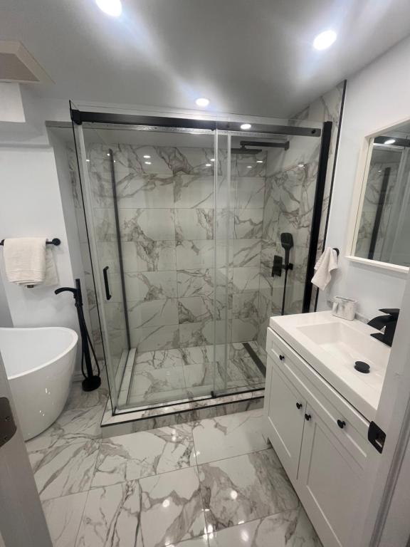 a bathroom with a shower and a sink at Cute and Cozy Studio with Private Parking in Montreal