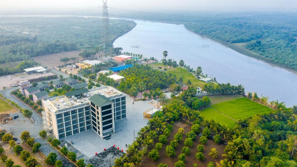 an aerial view of a building next to a river at Dhartii RiverView Resort in Jalālpur