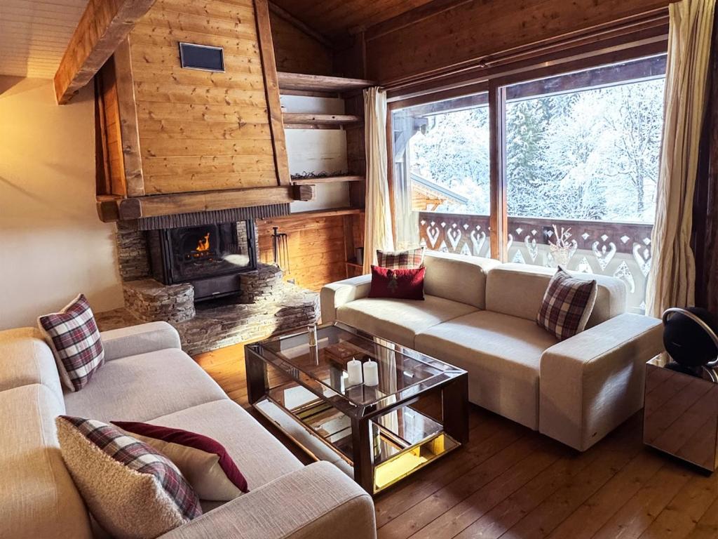 a living room with two couches and a fireplace at Exceptional Duplex, Cozy & Authentic Atmosphere in Les Gets