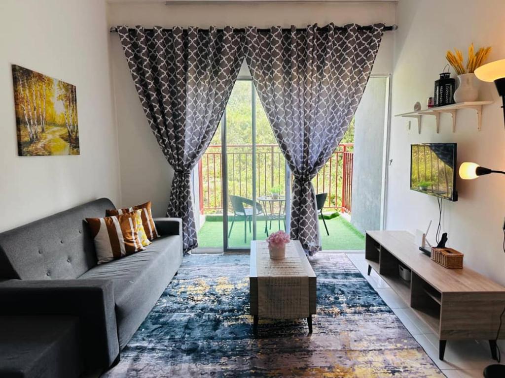 a living room with a couch and a large window at home in Brinchang