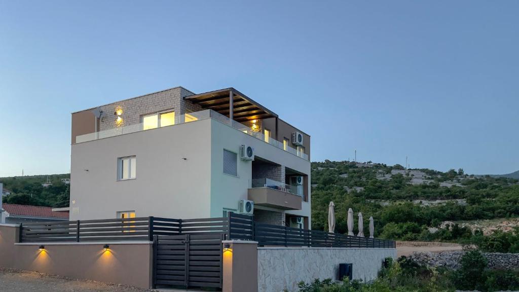 a large white house with a lot of balconies at Apartments King and Queen 2 in Povile