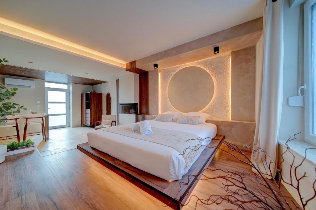 a bedroom with a large white bed in a room at Suite Moon & Spa in Amnéville