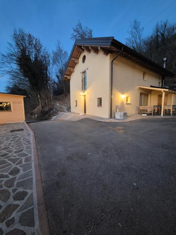 a building with lights on in a parking lot at Dimora del Serva in Belluno